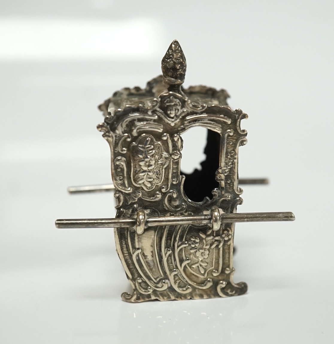 A small collection of miniature silver and white metal items including a cot by Saunders & Shepherd, Birmingham, 1896, 57mm, two filigree items, two Kiddush cups etc. Condition - poor to fair